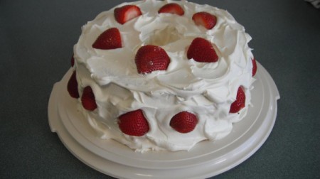 Gluten Free Strawberry Delight - Cake with frosting and strawberries.