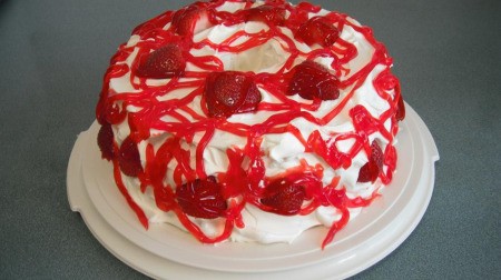 Gluten Free Strawberry Delight - Cake with strawberries, frosting and syrup.