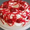 Gluten Free Strawberry Delight - Cake with strawberries, frosting and syrup.