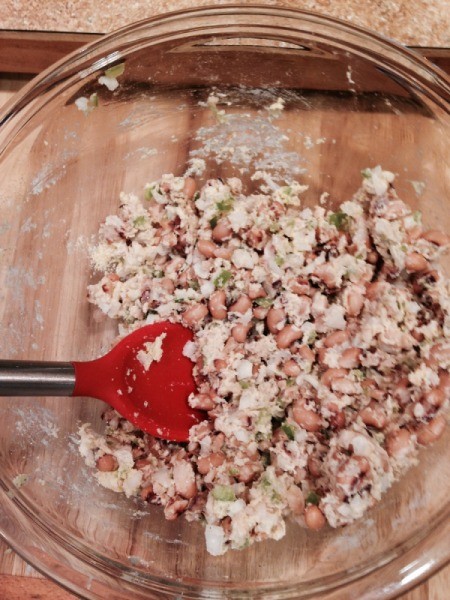 mashing peas with a spoon