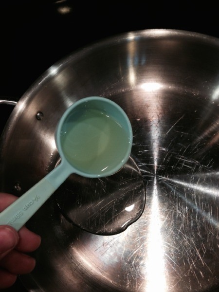 adding oil to skillet