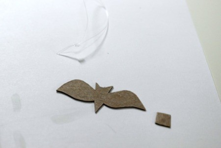 paper with fishing line hanger