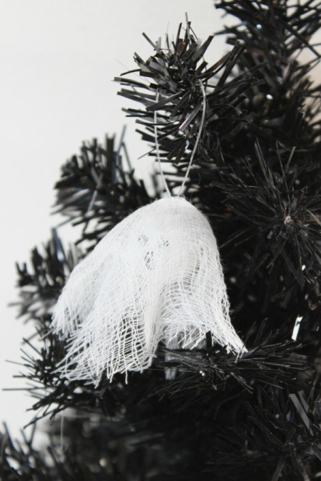 wooden ghost ornament on tree