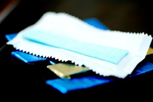 unwrapped gum on top of several foil wrapped pieces
