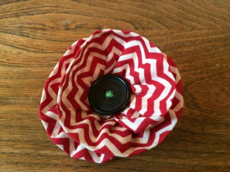 sew button into center of flower