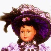 fancy dress doll in purple outfit with feather boa