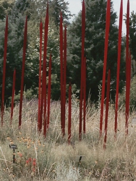 brillant red spears of glass rising up from a prairie setting