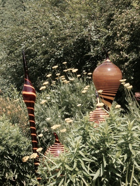 urns on top of thick stems tucked among the foliage
