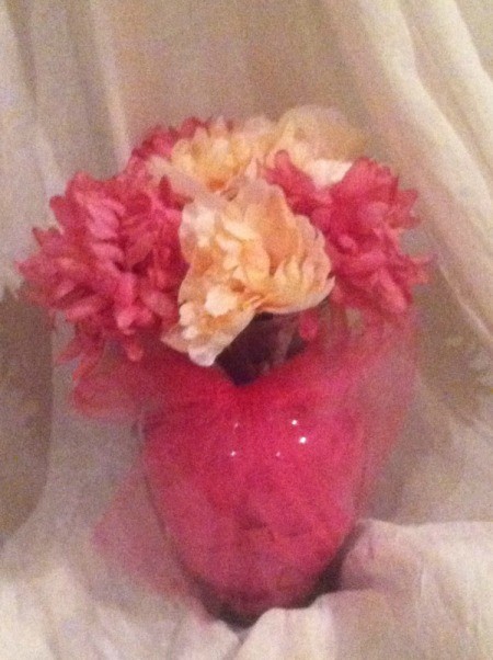 flowers in vase wrapped in bright pink tule