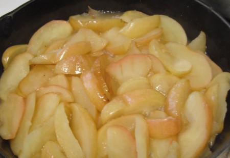 slices of apples frying in a skillet