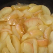 slices of apples frying in a skillet