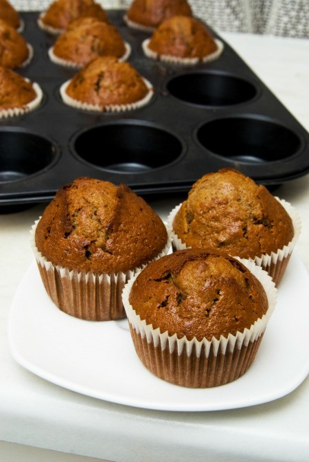 gingerbread cupcakes on plate in front of muffin pan