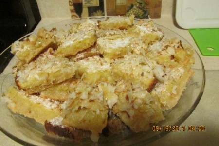 Plate piled with delicious looking lemon coconut squares.