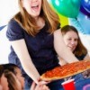 mom serving pizza at a birthday party
