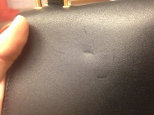 dent on leather purse