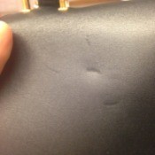 dent on leather purse