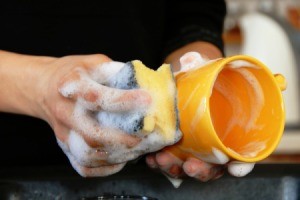 hands washing a cup