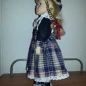 side view of doll in plaid dress