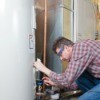man maintaining a water heater