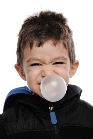 young boy blowing huge bubble