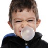 young boy blowing huge bubble