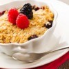 mixed berry cobbler in  white scalloped dish