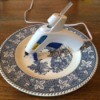blue and white plate with glue gun resting on it