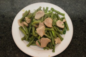 beans and pork on white serving dish