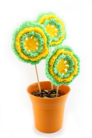 green and yellow crocheted flowers in pot