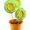 green and yellow crocheted flowers in pot