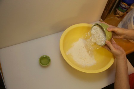 pouring flour into mixing bowl