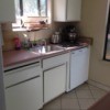 view of pink countertop and cabinets
