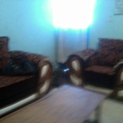photo showing blue walls and brown couch