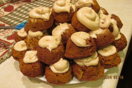 Individual Pumpkin Bundt Cakes - a stack of finished cakes on a plate.