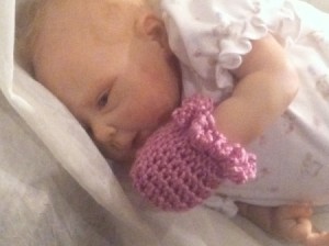 final photo of baby wearing a mitt