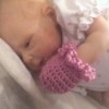 final photo of baby wearing a mitt