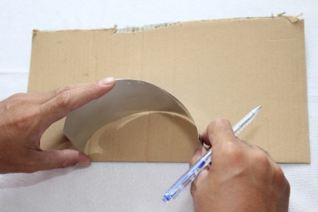 placing can in semicircle on cardboard