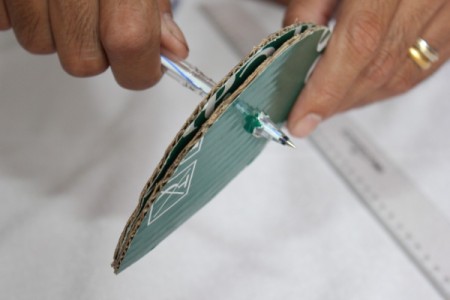 poking hole through cardboard