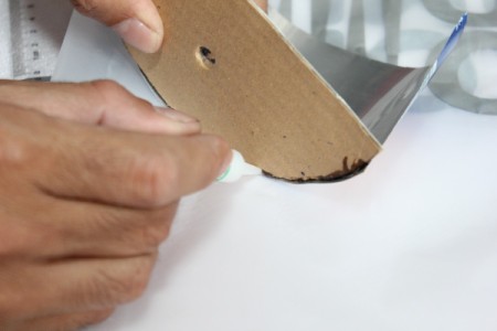 gluing cardboard to can
