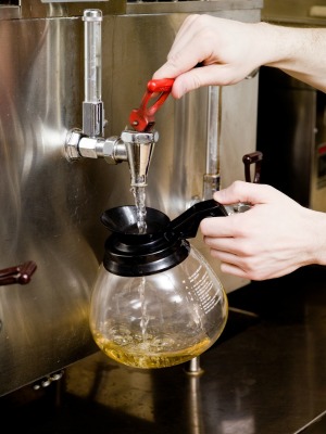 rinsing out a coffee pot with hot water