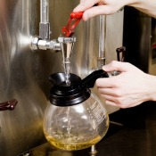 rinsing out a coffee pot with hot water