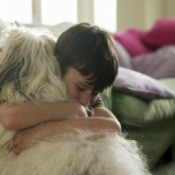 boy hugging a dog