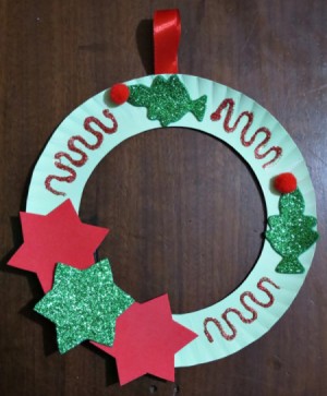 finishes wreath hanging on dark background