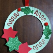 finishes wreath hanging on dark background