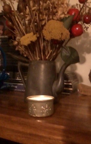 Finished candle holder with lighted candle.