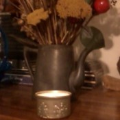 Finished candle holder with lighted candle.