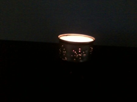 lit candle in the dark