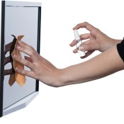 woman's hand cleaning a monitor