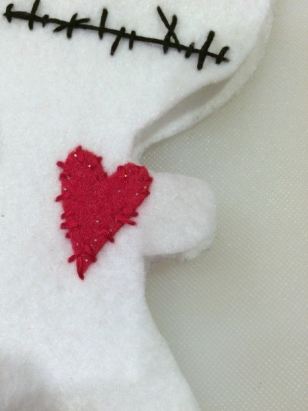 sew heart on doll