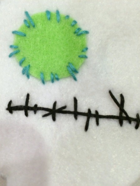 sew felt eyes on doll